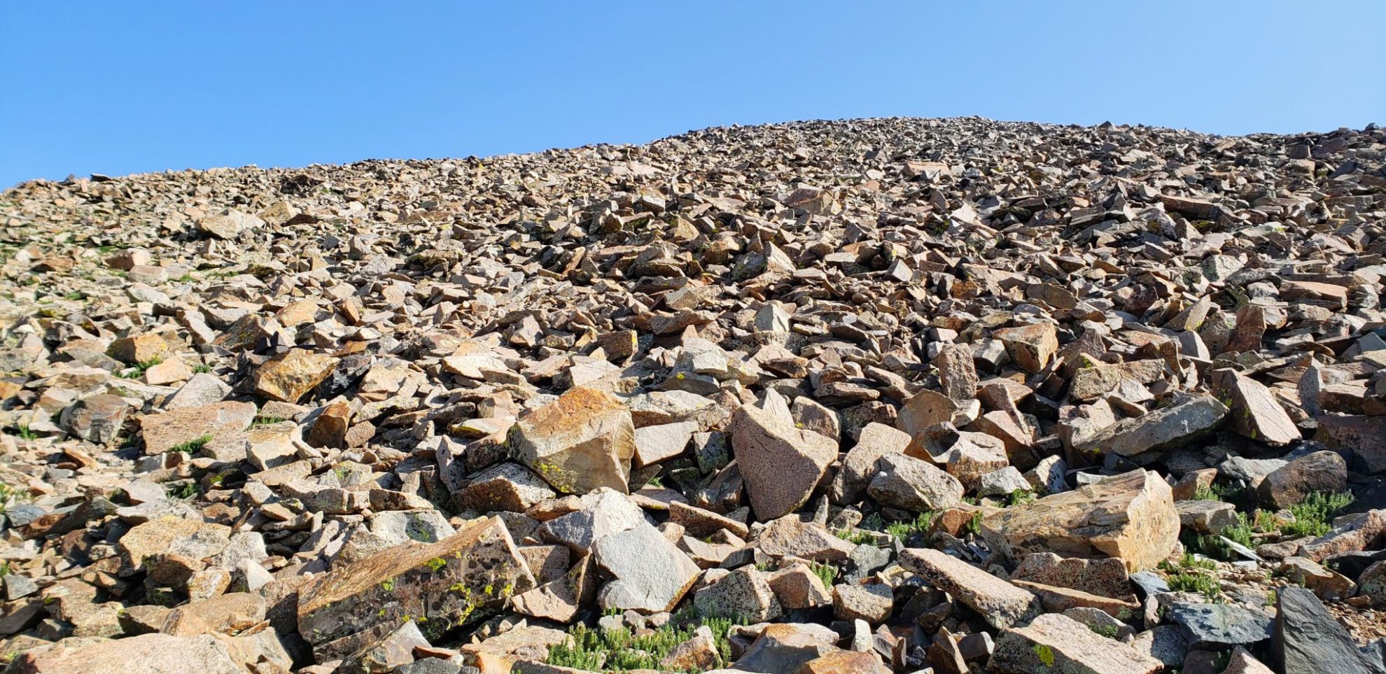 The final push to the summit over heavy talus