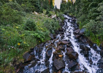 Crossing a waterfall along the trail.